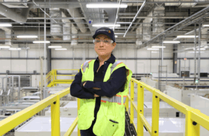 Engineer in safety vest inside industrial facility