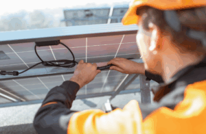 Technician connecting solar panel cables.